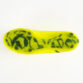 Bottom view of a neon yellow soccer cleat, showing its studded sole with dark green/black studs against a white background