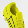 Bright neon yellow soccer cleat with black chevron stripes and laces (close-up of upper