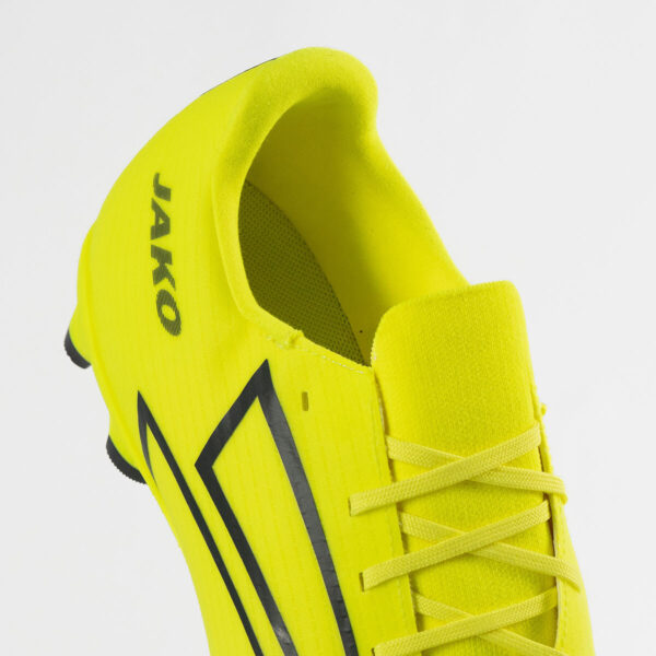 5551_676_P03 Bright neon yellow soccer cleat with black chevron stripes and laces (close-up of upper