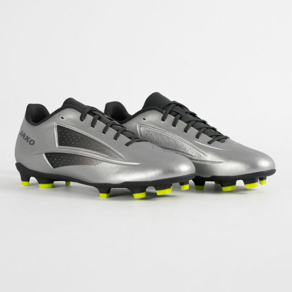 5553_677_P01 Pair of silver soccer cleats with black laces and neon yellow studs, brand JAKO visible on the heel.