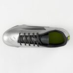 Top view of a silver athletic shoe with black laces and a green interior.