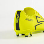 Bright yellow JAKO soccer cleat shown from the rear with a black RS69 strip and the JAKO logo visible on the side.