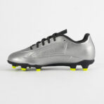 Side view of a silver soccer cleat with black laces and neon yellow studs on the sole.