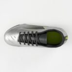Top view of a metallic silver soccer cleat with black laces and lime green inner lining.