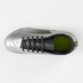 Top view of a metallic silver soccer cleat with black laces and lime green inner lining.
